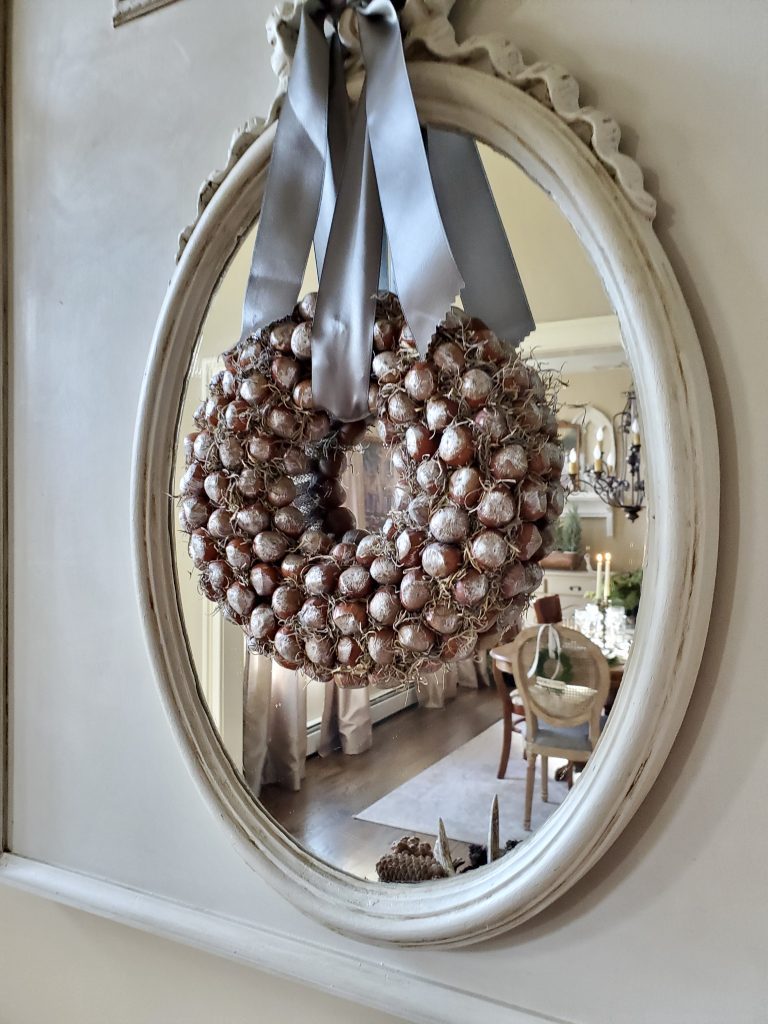 close up of hazelnut wreath across from christmas time in the dining room