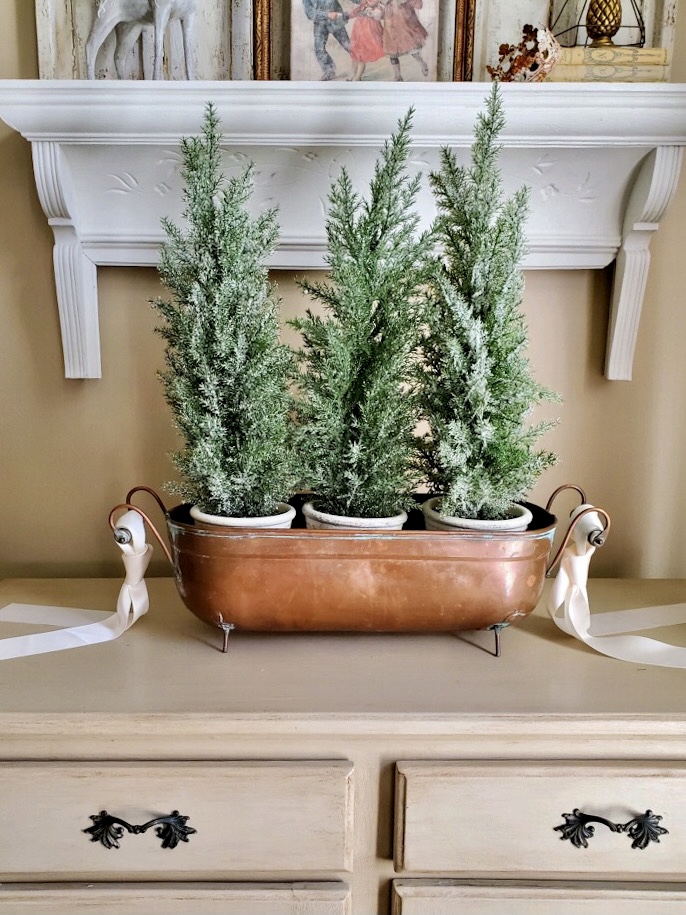 close up of the copper bucket ad the snow covered trees for christmas time in the dining room