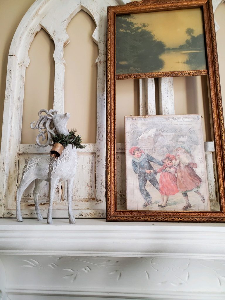 close up of a deer and christmas canvas on a shelf