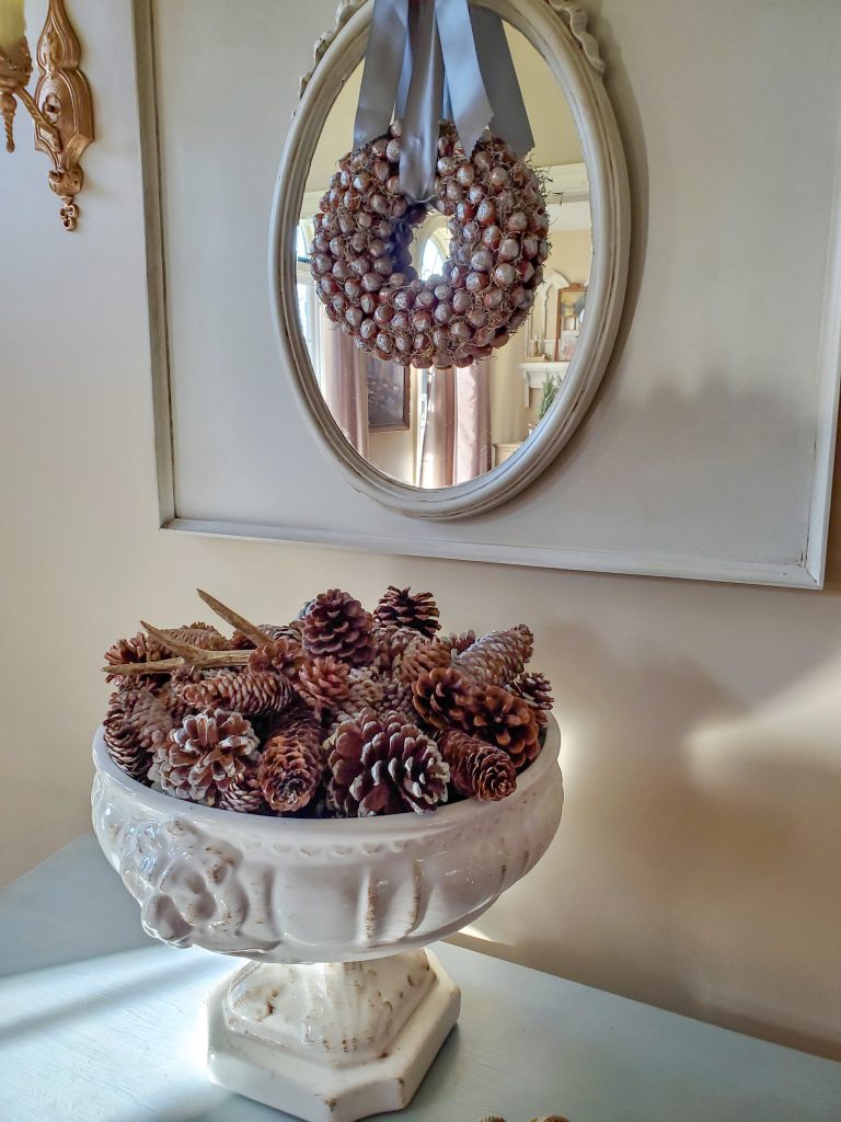 a large bowl filled with pinecones on the bombay chest