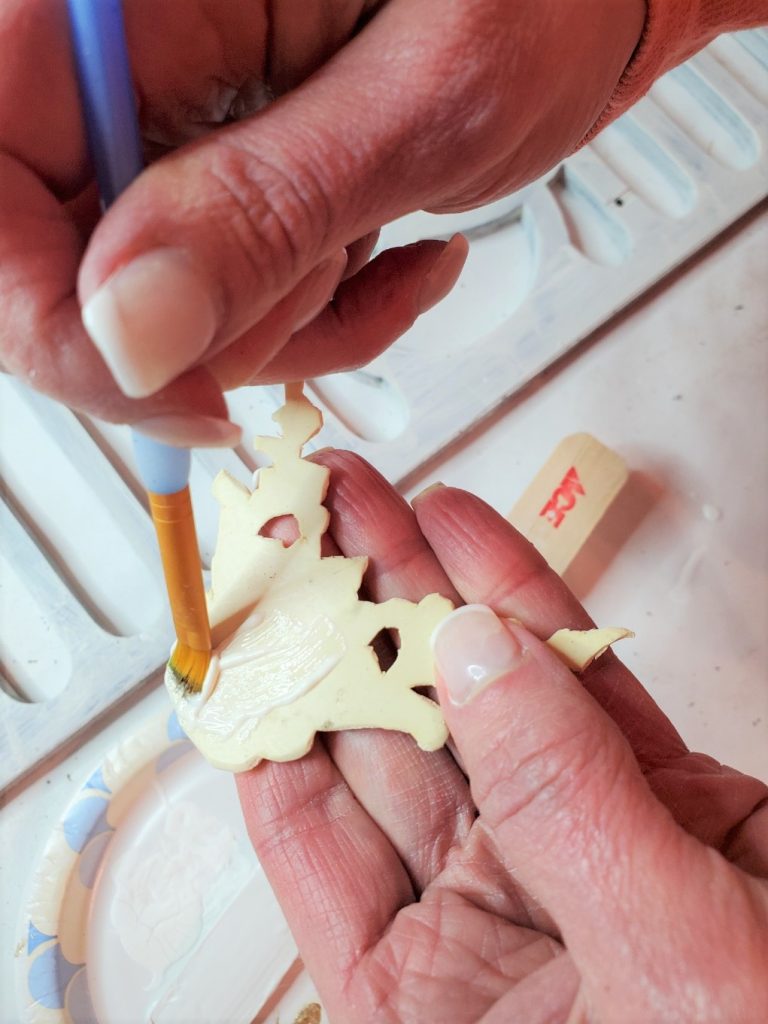 adding glue to the back of the appliques