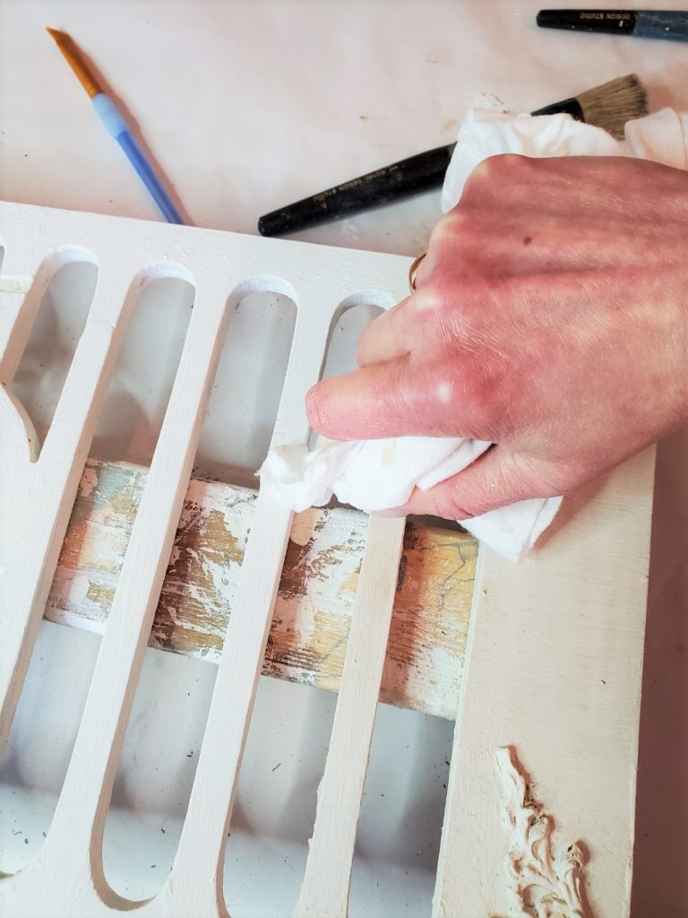 rubbing the wax into make old wood pretty