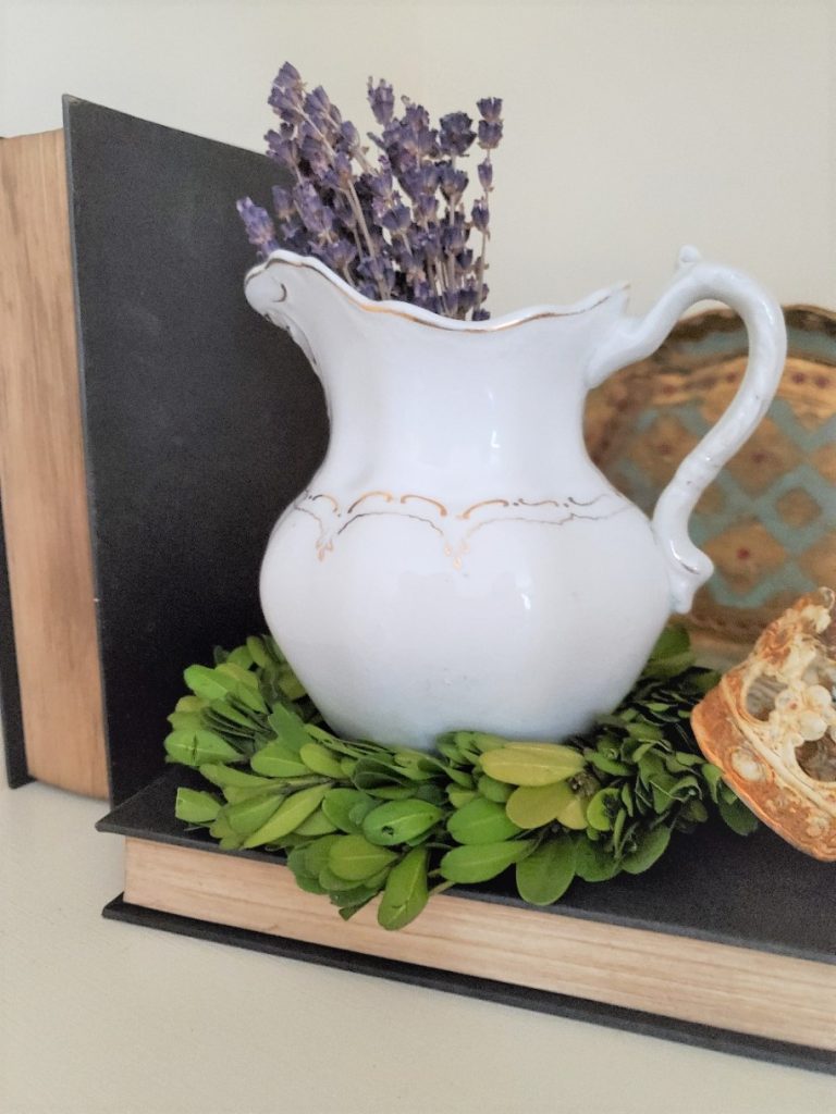 books, pitcher with dried lavender and small boxwood wreath