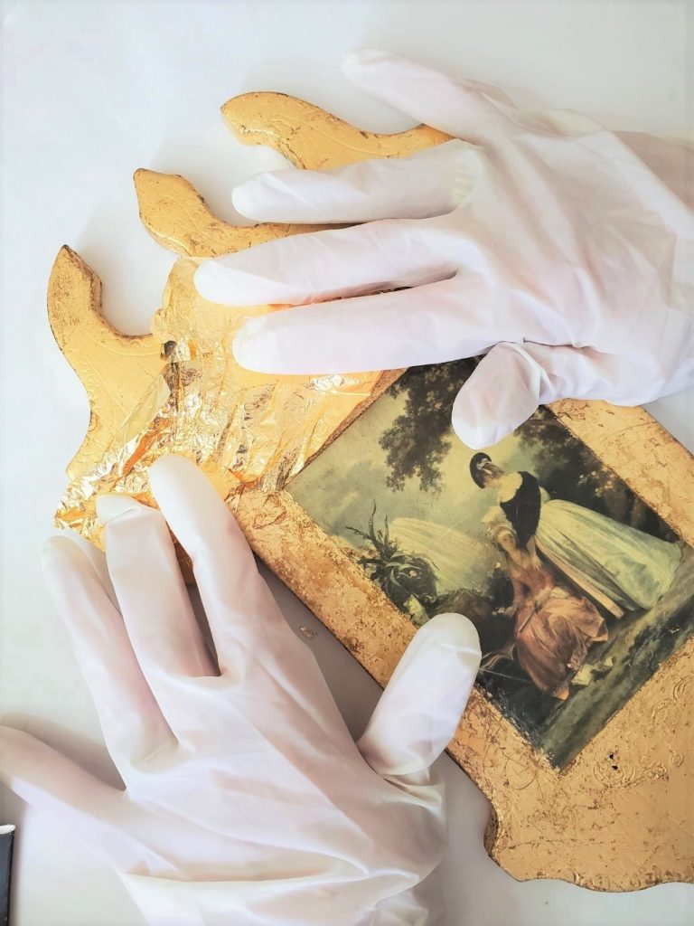 laying the DIY gold leafing sheets on the plaque