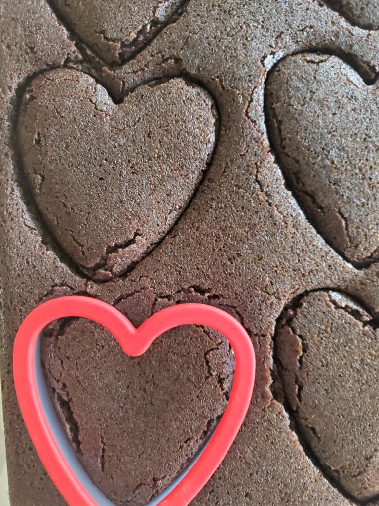 cutting the brownies on the cake side with a heart shape cookie cutter Easy Heart Shape Chocolate Brownies