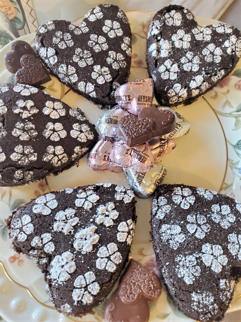 Easy Heart Shape Chocolate Brownies on a floral dish for serving with small heart covered shape chocolates