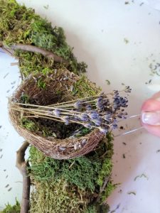pushing florist pin to hold the nest