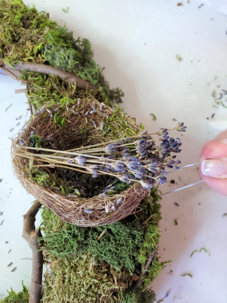pushing florist pin to hold the nest
