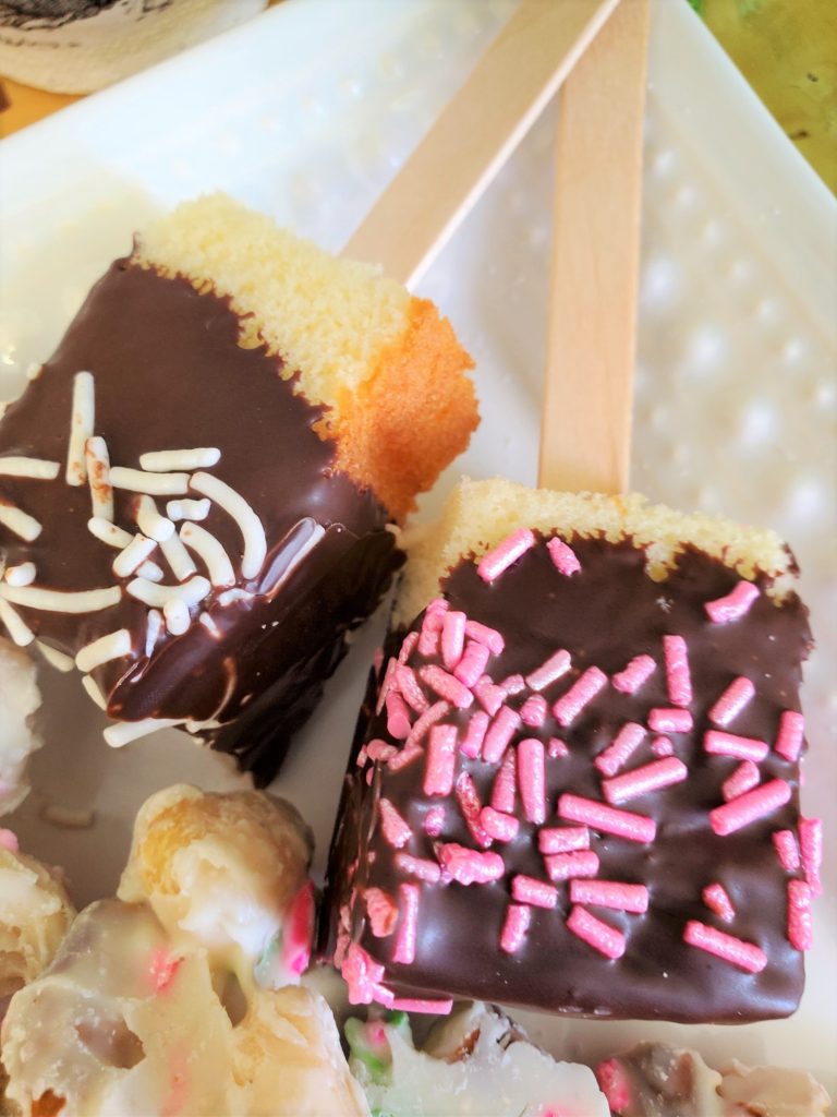 7 easy semi homemade Easter dessert ideas. pound cake pops covered in dark chocolate with white and pink sprinkles