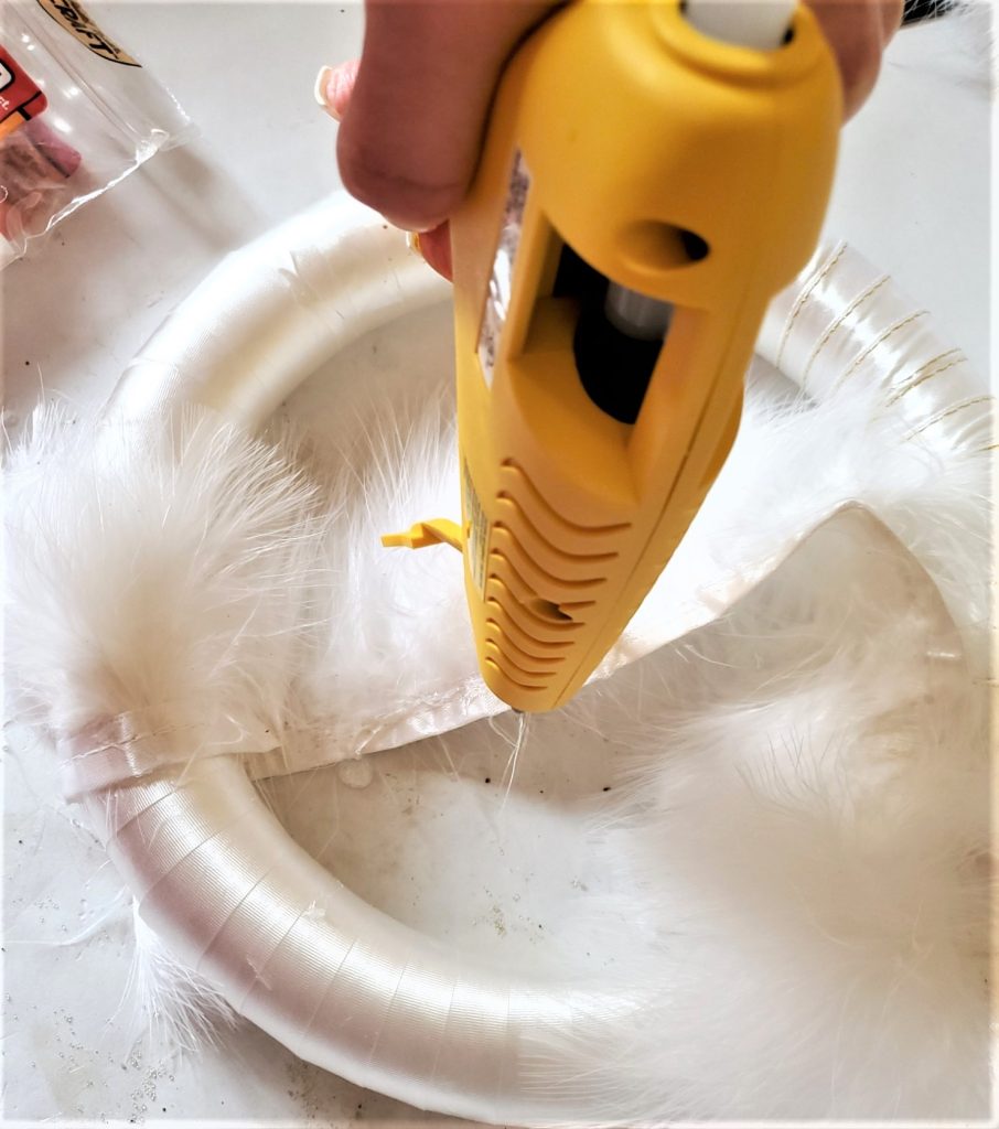 adding fur trim with satin to the Christmas wreath