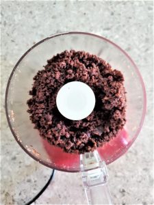 grinding leftover brownies in a food processor