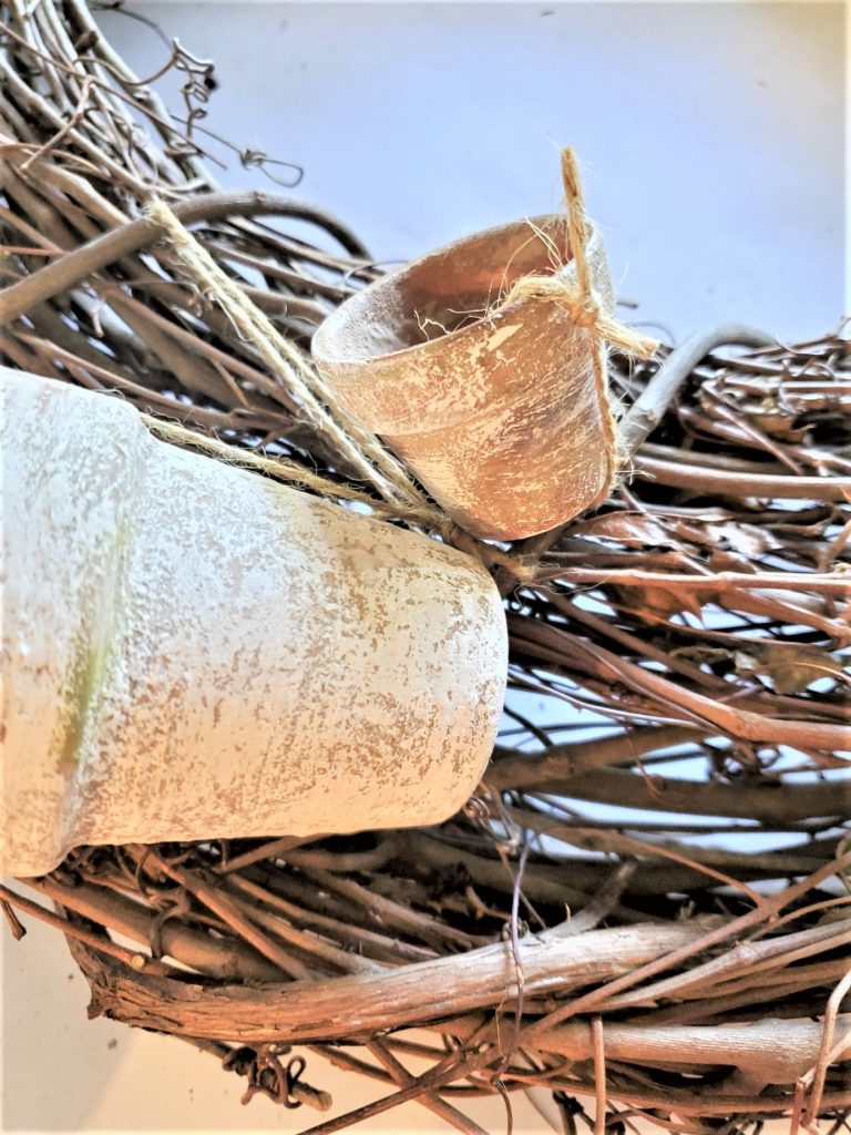adding little flowerpots for the easy DIY artificial eucalyptus flowerpot wreath