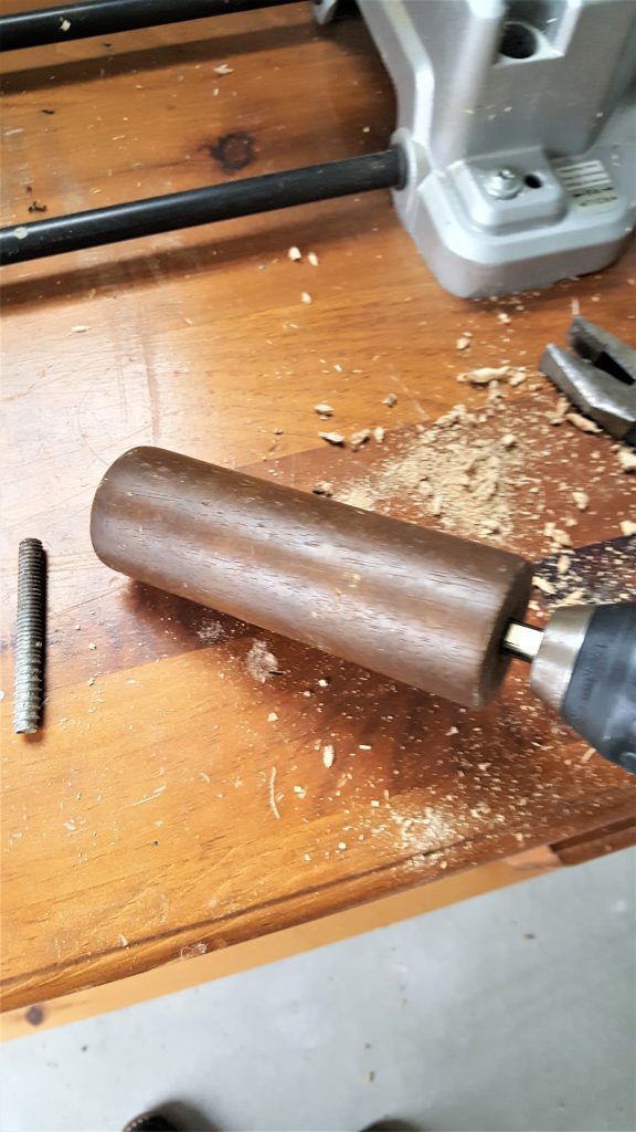 drilling the hole through the furniture leg for my DIY
