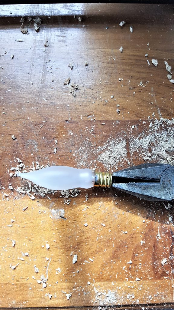pulling the tip of the end of the light bulb