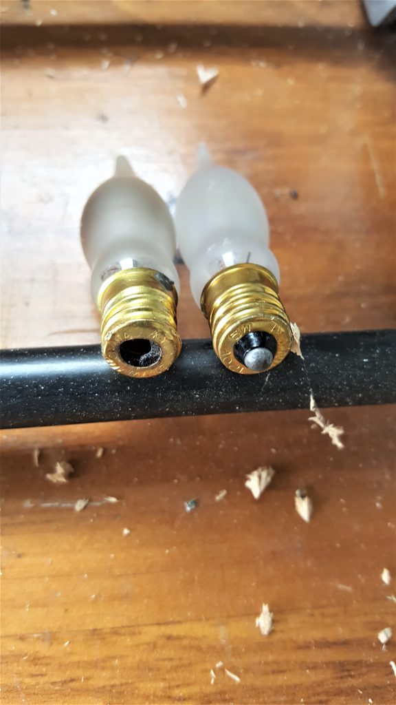 showing a new bulb next to a bulb with a hole on the end for my DIY