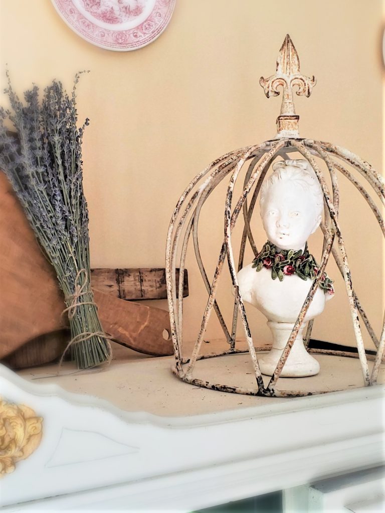 a metal ivory old cloche with a chalkware female bust