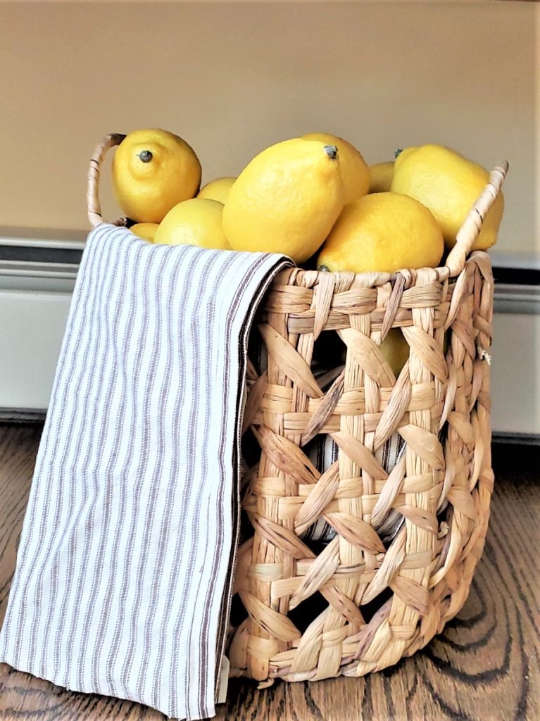a basket filled with lemons and an old towel