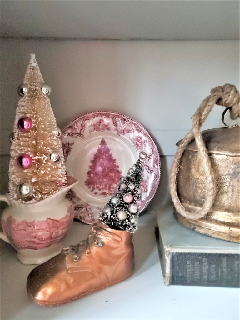 bottle brush trees, a bell and bronze baby shoe simple Christmas kitchen