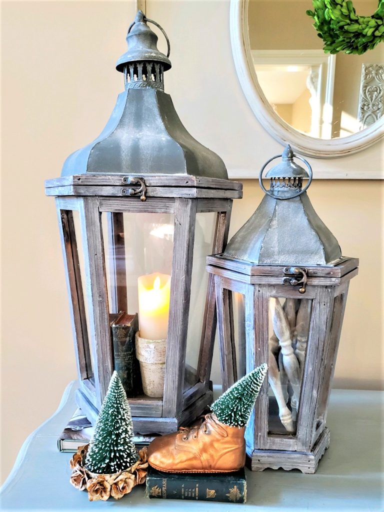 Large one filled with spindles and small books.  Bottle brush trees in front with one inside a crown and the other in a baby shoe