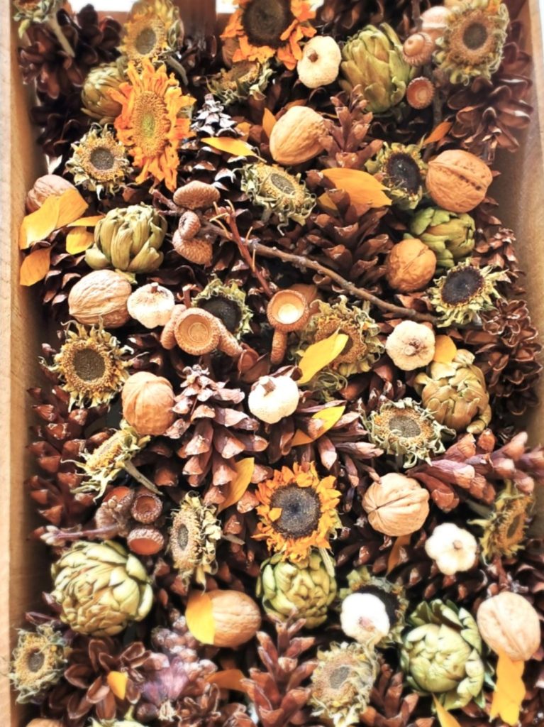 fall-centerpiece-ideas-on-a-budget-dried-sunflowers-acorns-pinecones-sticks-dried-artichokes-nuts