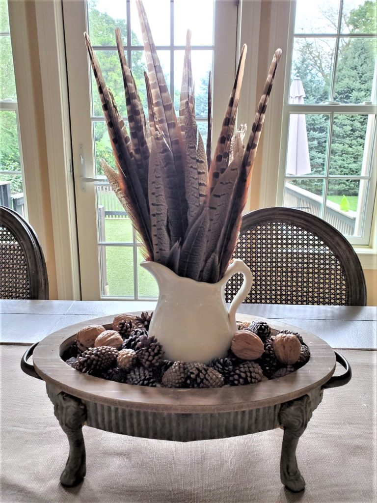 fall-centerpiece-ideas-on-a-budget-pheasant-feathers-in-a-tray-with-nuts-and-acorns