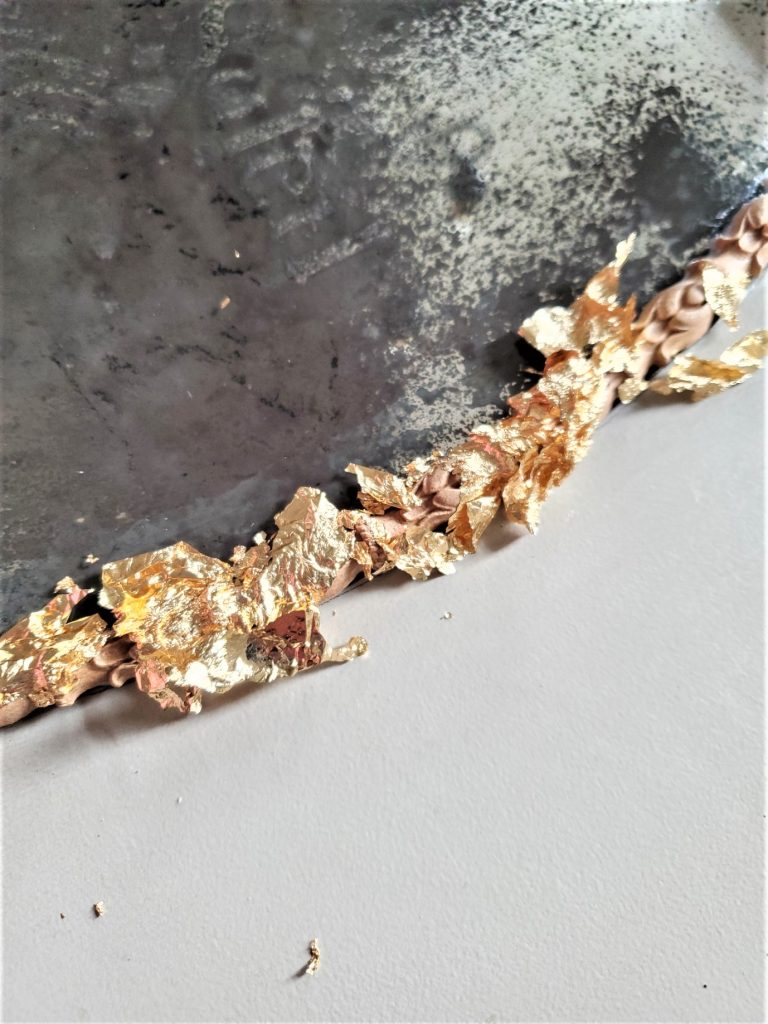 getting ready to smooth the metal leaf sheet