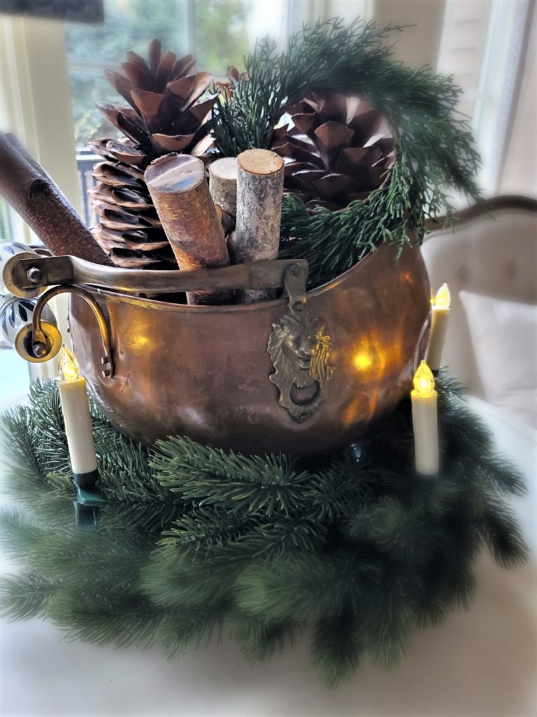 Old Fashioned Christmas Decorating Ideas a Closeup of an Antique Coal Skuttle filled with birch logs, large pine cones and a wreath