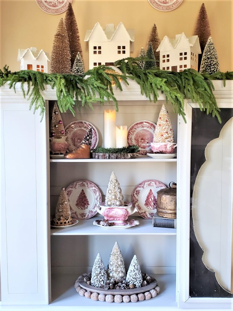 Old Fashioned Christmas Decorating Ideas Showing the Top of the Hutch with White Houses, Trees and Garland