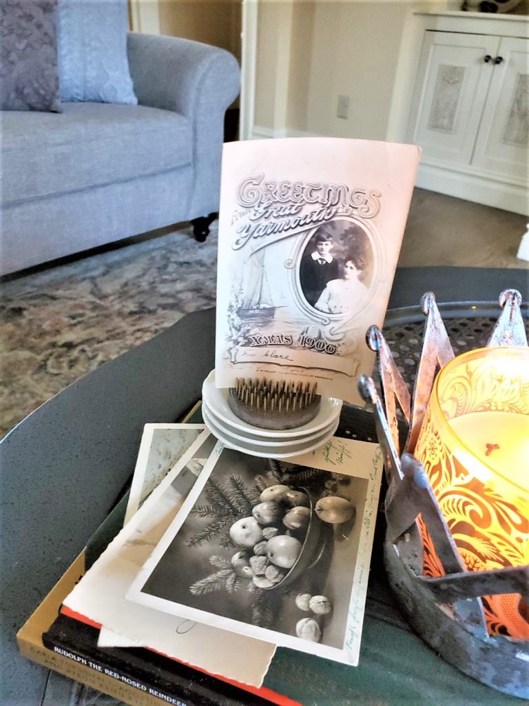 A Scented Candle Lit with Old Postcards from Europe for an Old Fashioned Christmas
