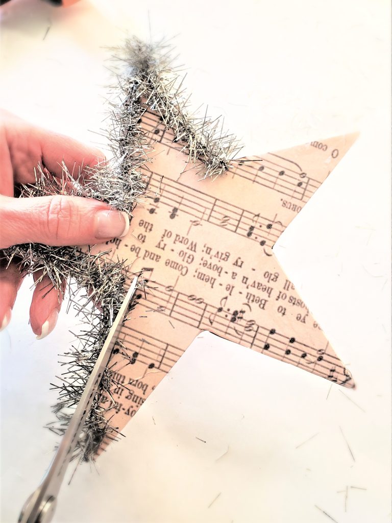 create-stunning-diy-christmas-tree-star-toppers-trimming-the-tinsel-garland-with-scissors-to-make-it-neater