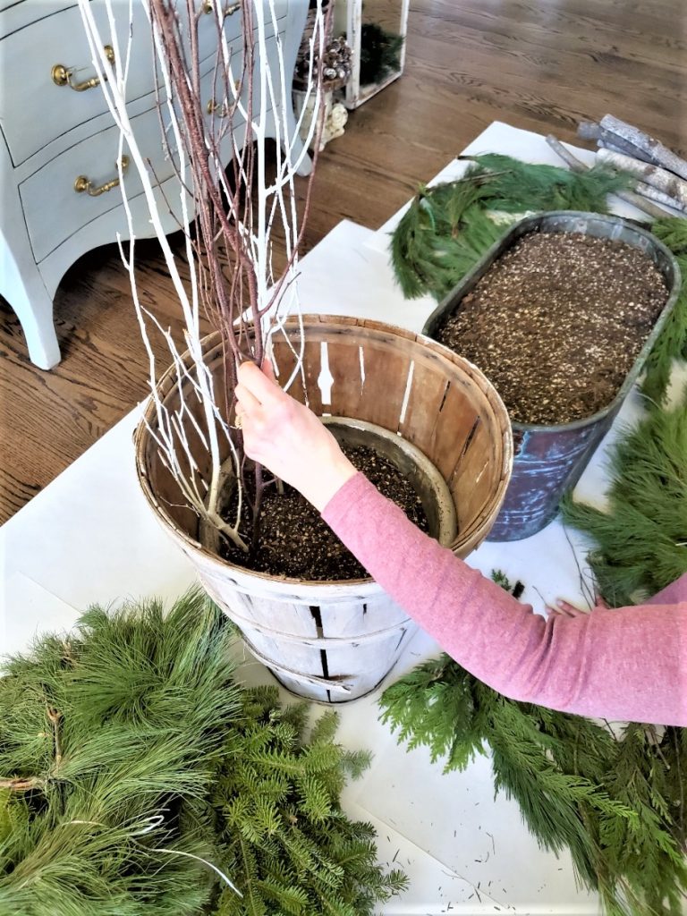 Me adding sticks to the basket