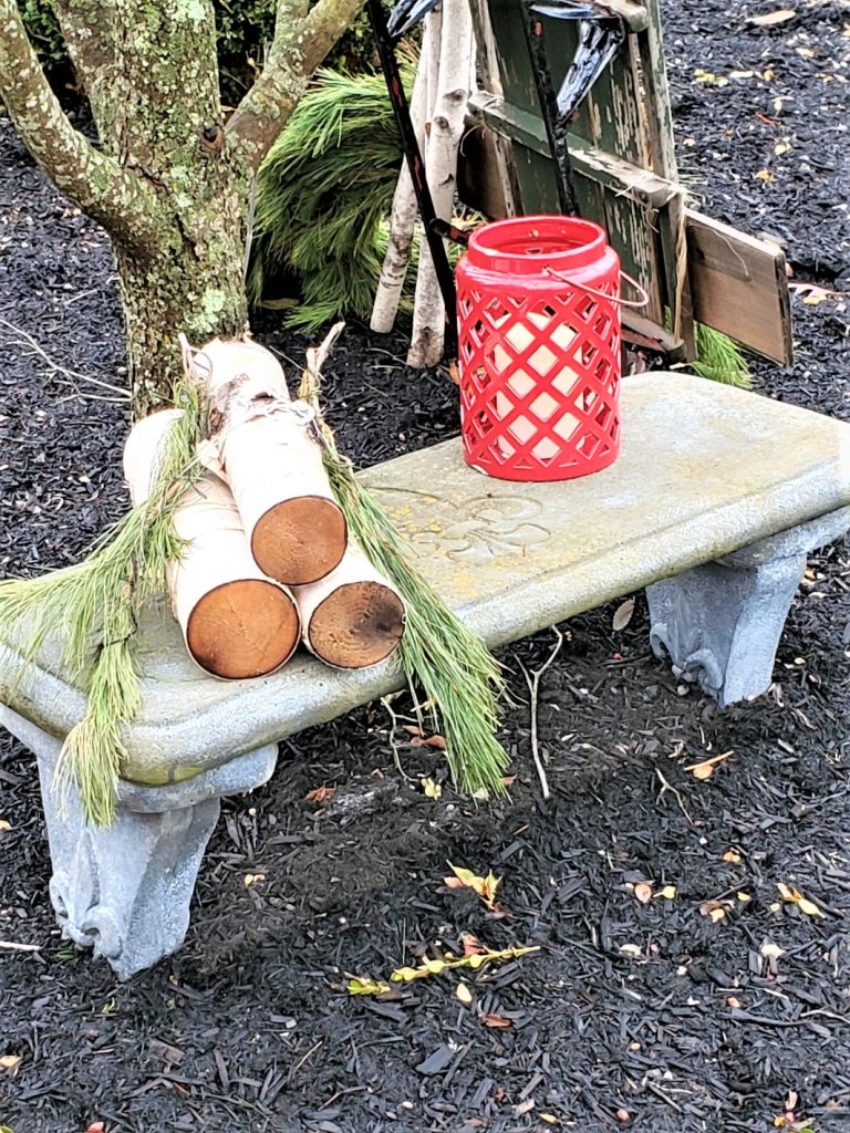 Bench with birch logs and red lantern