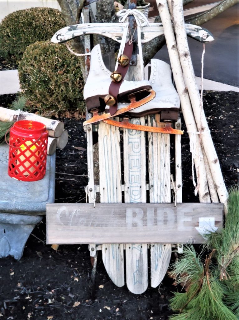 farmhouse front porch Christmas decorating ideas sled and skates at night