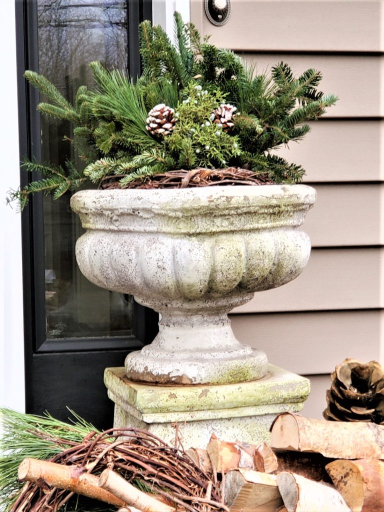 farmhouse front porch Christmas decorating ideas urn filled with greens