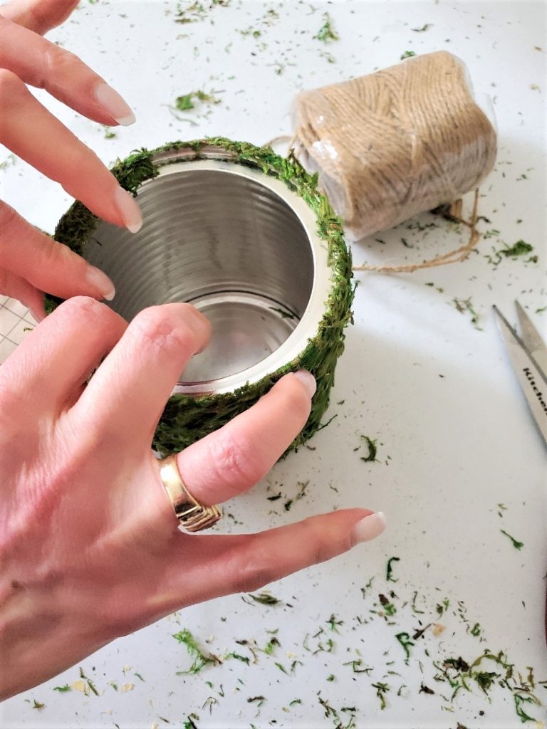 pushing-strips-of-moss-on-the-vase