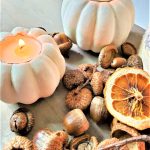 easy-pumpkin-candle-holders-add-cozy-vibes-one-pumpkins-two-small-pumpkins-lit-with-an-orange-slice-and-acorns