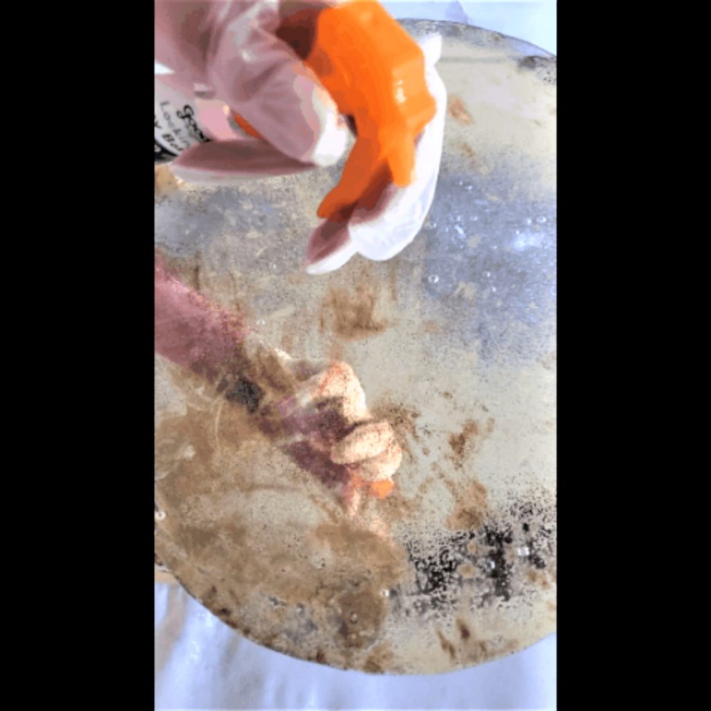 spraying-bleach-mixture-to-antique-mirror-video