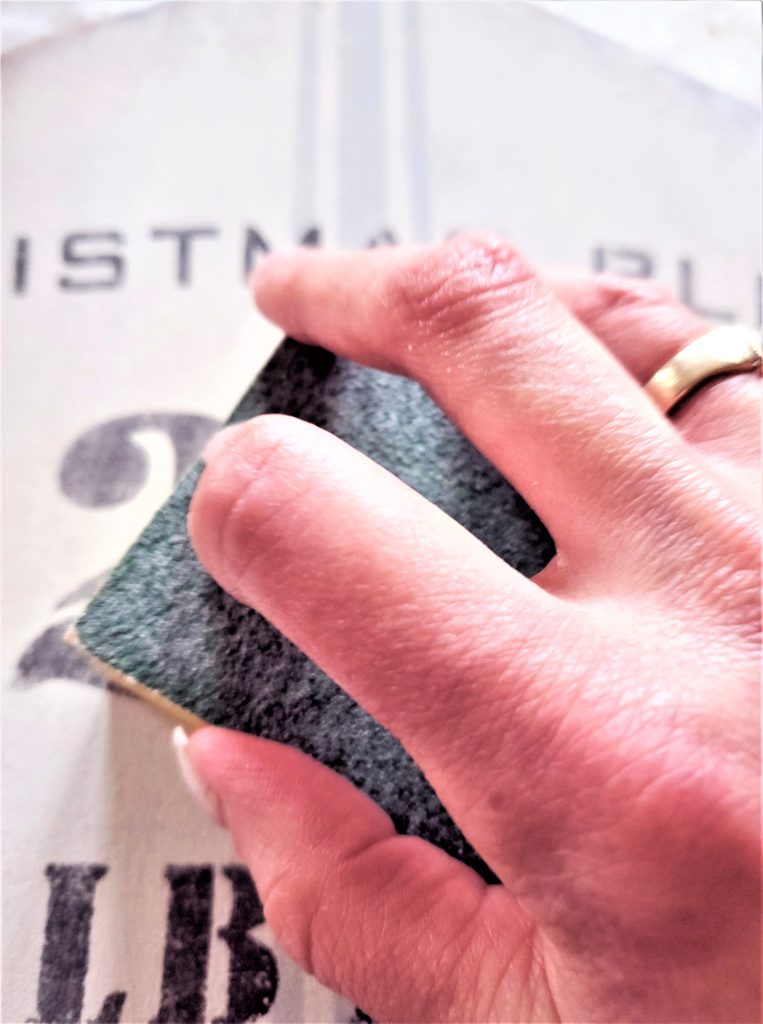 sanding-the-number-on-the-stencil-diy-christmas-sign