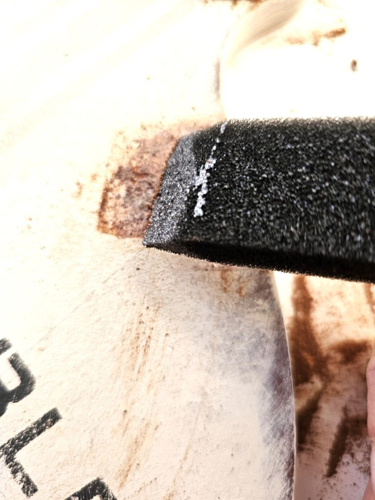 spice-up-rusty-jingle-bells-with-Mod-Podge now-glue-added-to-the-edge-of-wood-sign-over-the-dried-cinnamon-to-wood-sign
