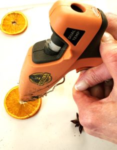 star-anise-garland-adding-glue-to-orange