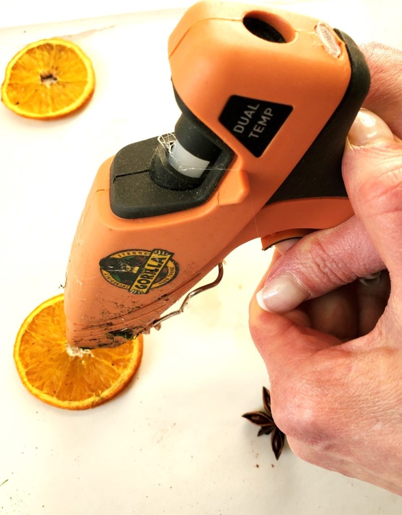 star-anise-garland-adding-glue-to-orange