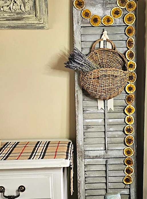 star-anise-garland-with-orange-hanging-on-shutter-with-basket-and-dried-lavender