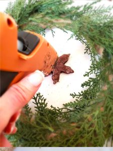 gingerbread-salt-dough-wreath-adding-glue-to-snowflake