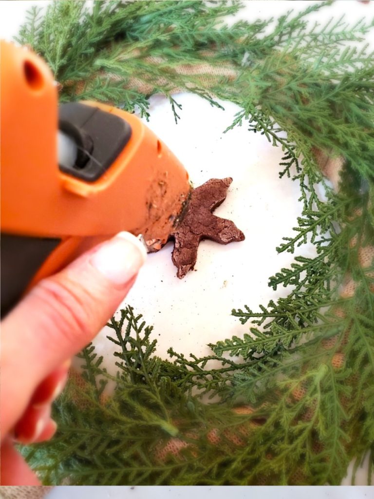 gingerbread-salt-dough-wreath-adding-glue-to-snowflake