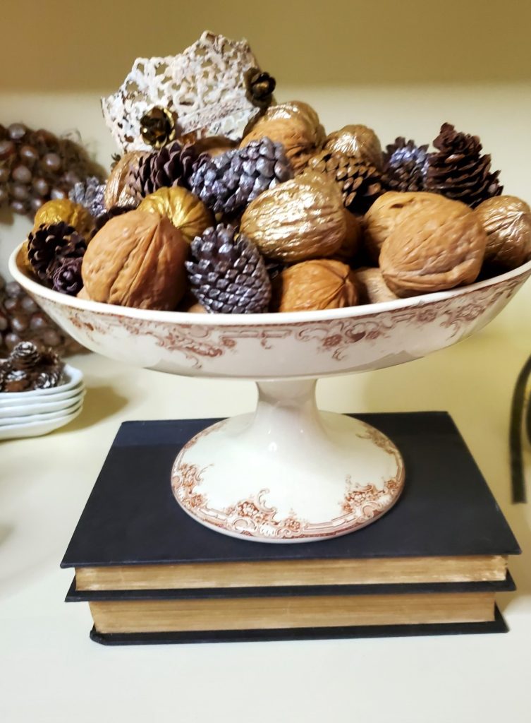compote-filled-with-nuts-pinecones-and-crown