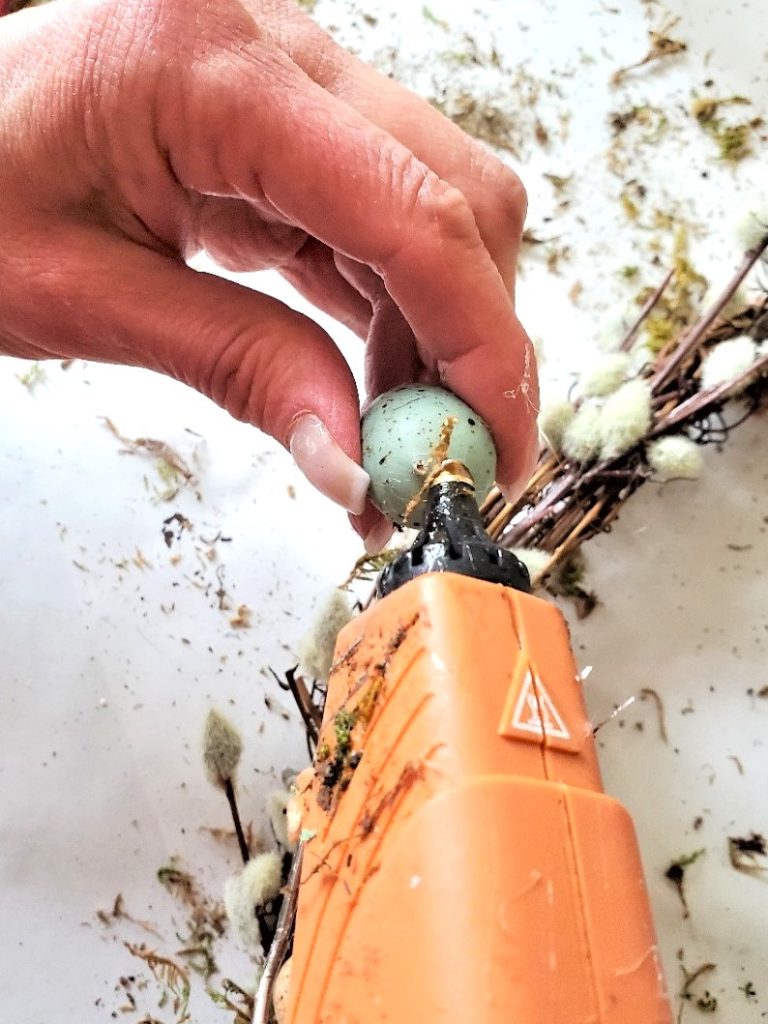 easy-natural-spring-wreath-adding-hot-glue-to-egg