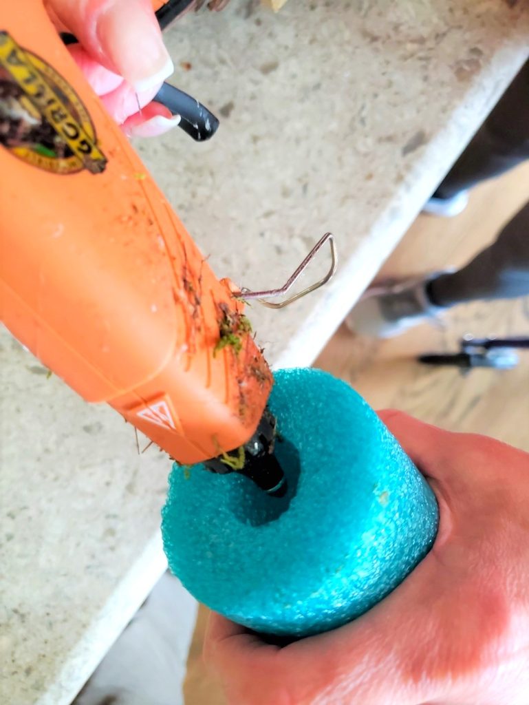 asy-pool-noodle-grapevine-wreat-adding-hot-glue-in-hole