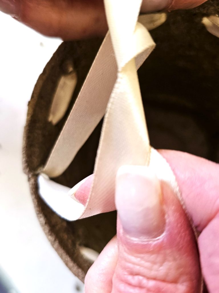 tying-a-knot-in-ribbon-to-kep-it-tight
