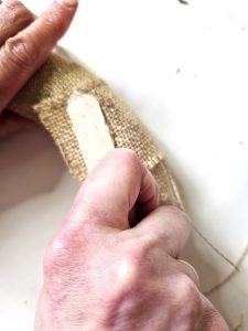 holding-popsicle-stick-for-burlap-to-set