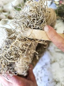 holding-spanish-moss-to-set-outer-part-of-wreath